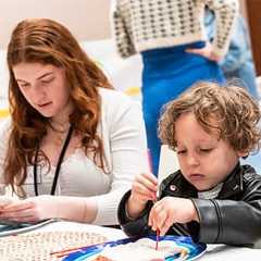 Teen and child seated at a table, focused on hands-on art activities with modeling clay and paint.