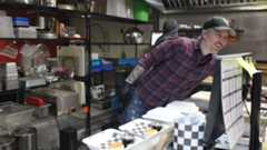 Malcolm Bedell working in the kitchen.