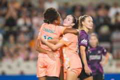 Image of Simone Charley and Ally Lemos celebrating a goal against the Houston Dash.