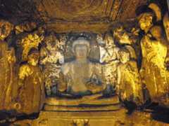 ajanta caves carving of buddha surrounded by bodhisattvas