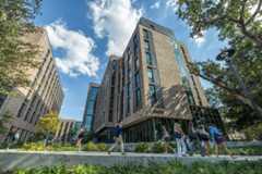Students walk past Fogelman Residence Hall