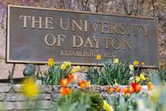 Photo of flowers and UD entrance sign