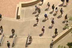 Students head up and down the bottom stairs of Alkek Library, Monday, August 23, 2021, at Texas State.