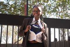 Marketing freshman Edee Dillard poses in her Clark Kent costume, Monday, Oct. 20, 2025, at the LBJ Mall.
