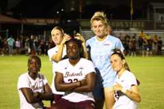 Members of the Texas State soccer team pose postgame following a match against Southern Miss. Texas State won 6-1