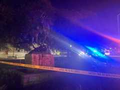Police lights illuminate the John Coffee Hays statue after three people were shot at The Square, Saturday, Nov. 1, 2025, at the Hays County Courthouse. The shooting killed one person and injured two.