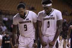 Texas State players Kyndall Davis (9, left) and DJ Hall (0, right) celebrate Dimp Pernell's and-one against Abilene Christian, Tuesday, Nov. 18, 2025, at Strahan Arena. The Bobcats won 63-49.