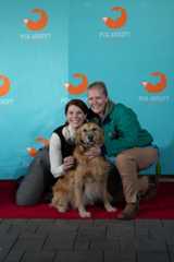 Business management and international business alumna  Olivia Nash (left) poses with a dog and its trainer on the red carpet for the “Hi.” movie premiere, Wednesday, October 29, 2025, at Front Yard Brewing.