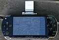A PlayStation Portable with OpenStreetMap data on screen.