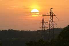 Setting sun and transmission towers. Flaten, Orhem, Stockholm, Sweden