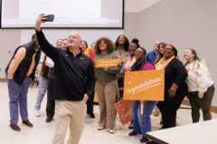 Keith Carver, senior vice chancellor and senior vice president for the UT Institute of Agriculture, takes a selfie with Genesis Nolan and others after her Torchbearer surprise.