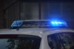 A police car with blue lights on top.