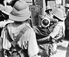 A wounded member of the “Lost Battalion” is carried to an ambulance after the fighting at Sihang Warehouse. 