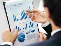 a person looking over report with multiple charts and graphs