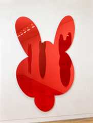 A red-tinted mirror shaped like the head of a kangaroo.