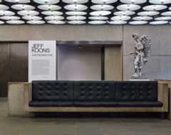 Lobby of the Whitney with Koons statue in the background.