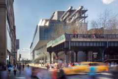 A view of the Museum with people and traffic in the foreground. 