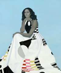A woman in a patterned dress sits against a light blue background, resting her chin on her hand, with a thoughtful expression.