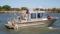 captain and three scientists aboard research vessel