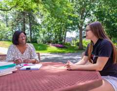 Advisor sitting with student
