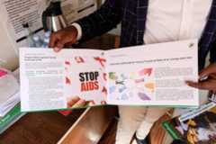 Kruish Mubiru, Executive Director of Uganda Young Positives (UYP) displays a pamphlet on HIV prevention in his office on February 12, 2025 in Kampala, Uganda. (Hajarah Nalwadda/Getty Images)