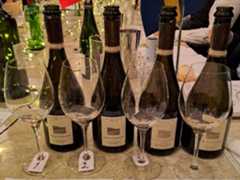 Claude Cazals Clos Cazals Champagne Blanc de Blancs lined up ready for tasting with numbers and glasses with a Swedish and Frenchflag behind on a white table cloth covered table