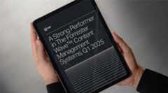 Person holding tablet displaying a Forrester Wave report for WordPress VIP, Q1 2025