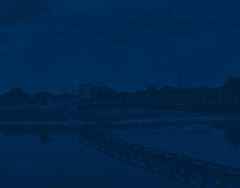 UM-Flint walking bridge background image with blue overlay