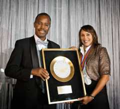 Poet Natasha Trethewey receives the Golden Plate from Benjamin Carson.