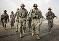 General David Petraeus (front left) joins U.S. soldiers in the village of Jadihah, Iraq, north of Baghdad in 2007. (AP Photo/Khalid Mohammed)