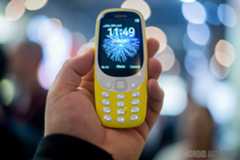 Front side of the new Nokia 3310 held in hand with the display turned on.