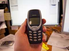 Front side of the old Nokia 3310 held in hand.