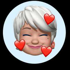Smiling Memoji face - an older woman with short, white hair