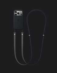 iPhone 17 Pro, back exterior, silver finish, with black Silicone Case with MagSafe and dark grey Crossbody Strap attached