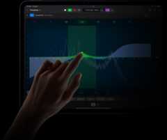 Hand touching an iPad Pro screen to edit a sound wave in Logic Pro for iPad on iPad Pro.
