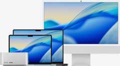 The macOS Tahoe wallpaper across family of Mac models from left to right: Mac Studio, 13-in MacBook Air in Sky Blue, 14-in MacBook Pro in Space Black, and 24-in iMac in Silver