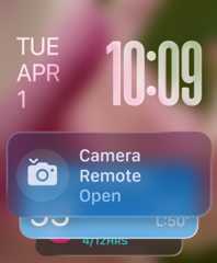 Remote Camera widget appears at bottom of screen, translucent time numerals top right, date top left