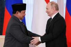 2025年6月19日、ロシア・サンクトペテルブルクで開かれた国際経済フォーラムで、握手するプーチン大統領（右）とインドネシアのプラボウォ大統領=AP