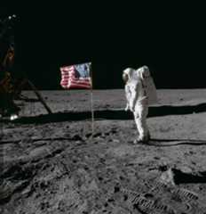 Edwin E. "Buzz" Aldrin Jr. poses for a photograph beside the American flag on the Moon. The footprints of the astronauts are visible in the soil of the Moon. Neil A. Armstrong took this picture with a 70mm Hasselblad lunar surface camera. Credit: NASA.