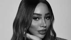 Munroe Bergdorf with her chin rested on her hand