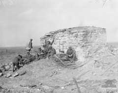 Australian troops resting behind a conspicuous pillbox, south east of Anzac Ridge in the Ypres sector, 26 September 1917