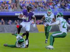 Ravens wide receiver Zay Flowers leaps over Jets linebacker Jamien Sherwood in Sunday's 23-10 win. Flowers was one of the team's few offensive bright spots in a low-scoring victory. (Karl Merton Ferron/Staff)