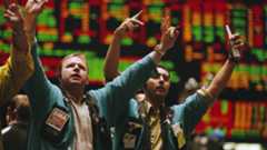 traders waving arms on the exchange floor
