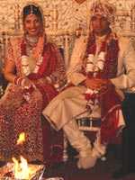 Hindu wedding ceremony in which bride and groom sit on chairs before the ceremonial fire