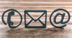 Contact, Accessibility, Picture: AdobeStock The image shows symbols for a telephone, an email inbox and an @ sign against a wooden background