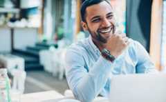 smiling man with laptop learning about the media centre