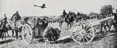 French 75mm field gun, with aircraft in the background, during the Battle of the Marne, fought from 6th to 9th September 1914, during the First World War