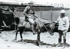 Winston Churchill (on the pony) by the wrecked railway trucks of the Armoured Train at Chieveley on 15th November 1899