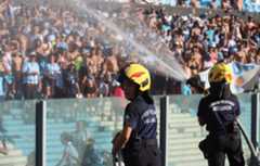 Firefighters spray water at people due to intense heat during a football game in Argentina.