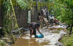 Residents cleaning the mud after tropical storm Kristine flooded Lemery, Philippines, 25 October 2024. Credit: ZUMA Press, Inc. / Alamy Stock Photo. Image ID: 2YD4WRX.